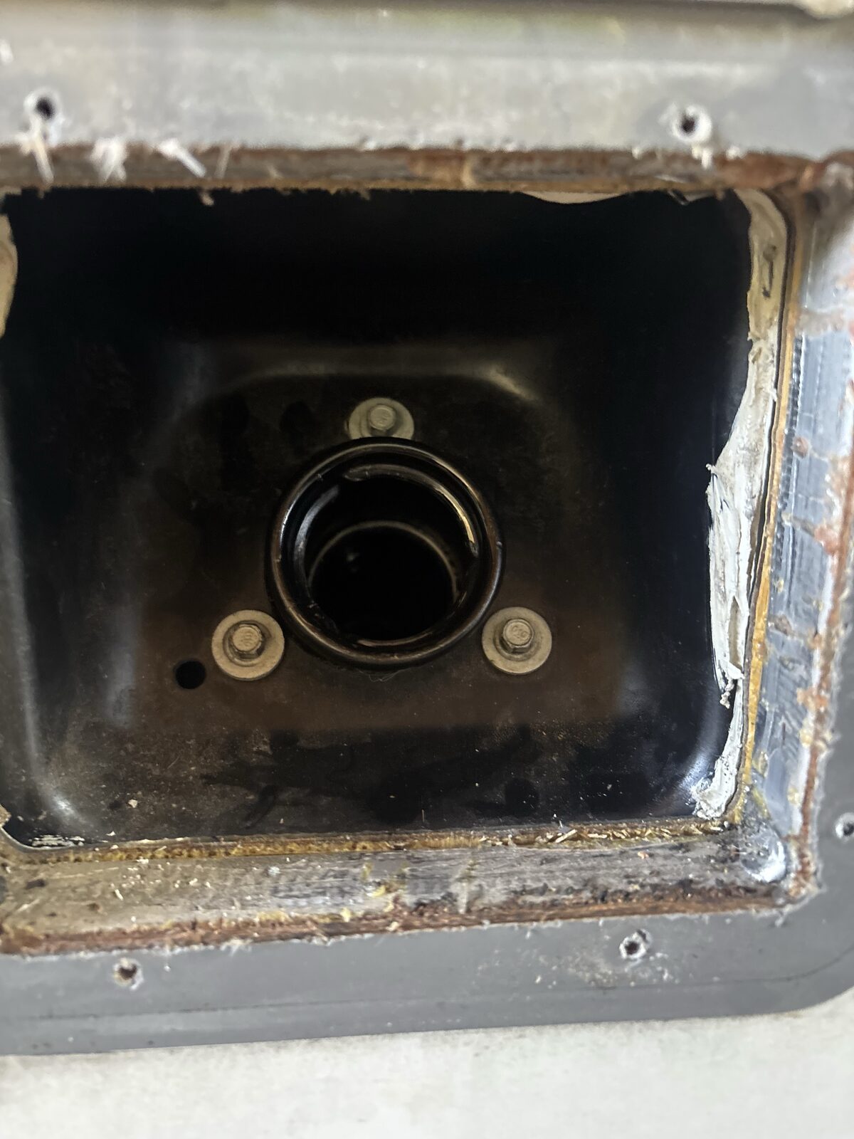Another failed factory door removed — the RV Fuel Vault bolts on over this same opening with no cutting or drilling