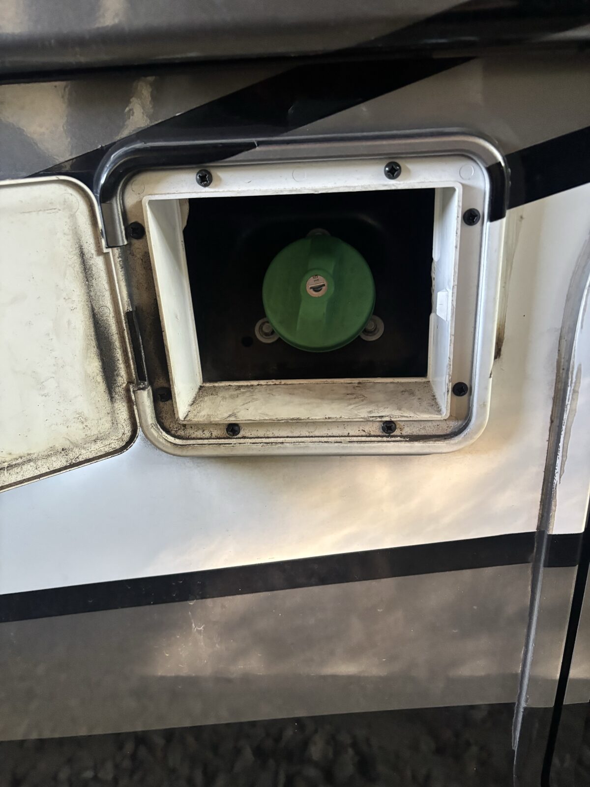 The recessed factory cutout and diesel fuel fill on the same Thor coach