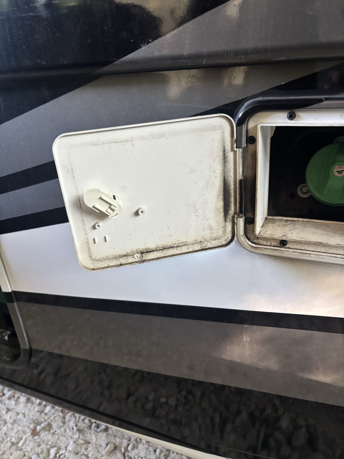 Open factory fuel door on a Thor Omni diesel Super C exposing the fuel cap