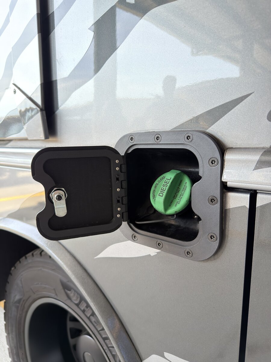 RV Fuel Vault open on motorhome — low angle showing locking mechanism and diesel cap